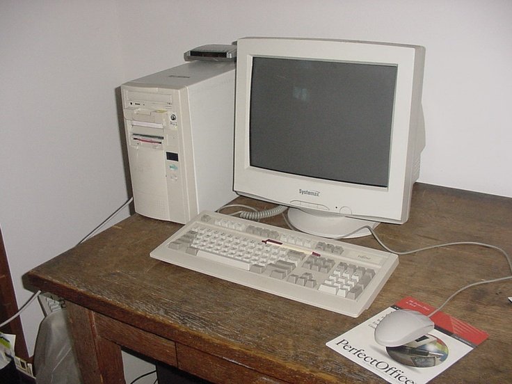 Ordenador antiguo con monitor CRT y teclado clásico sobre escritorio, típico PC retro de los años 90